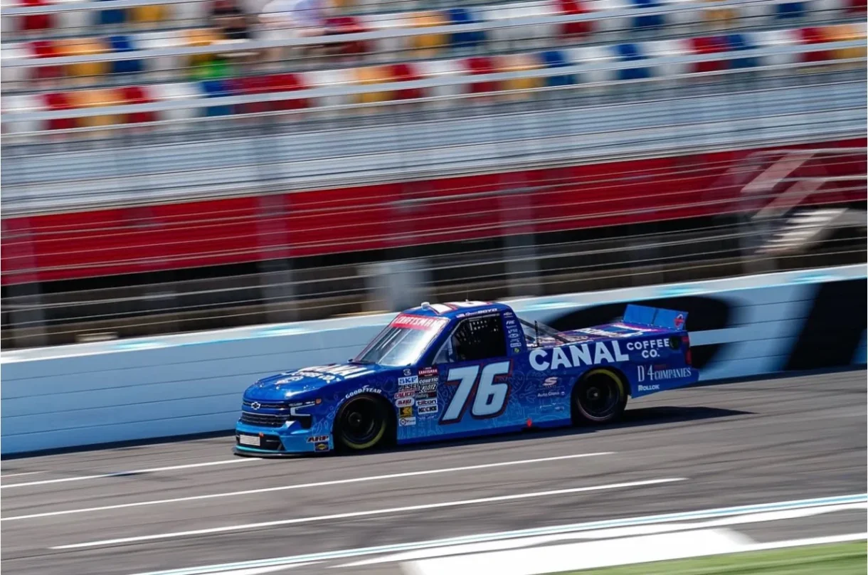 Canal Coffee Co. race truck driving on a racetrack.