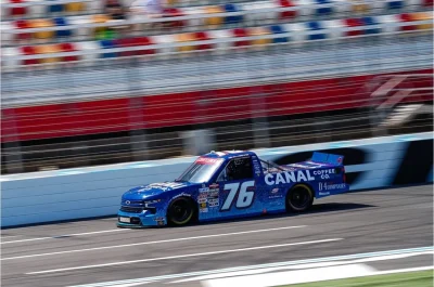 Canal Coffee Co. race truck driving on a racetrack.