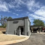 Canal Coffee Co. building exterior with drive-thru lane under a cloudy sky.